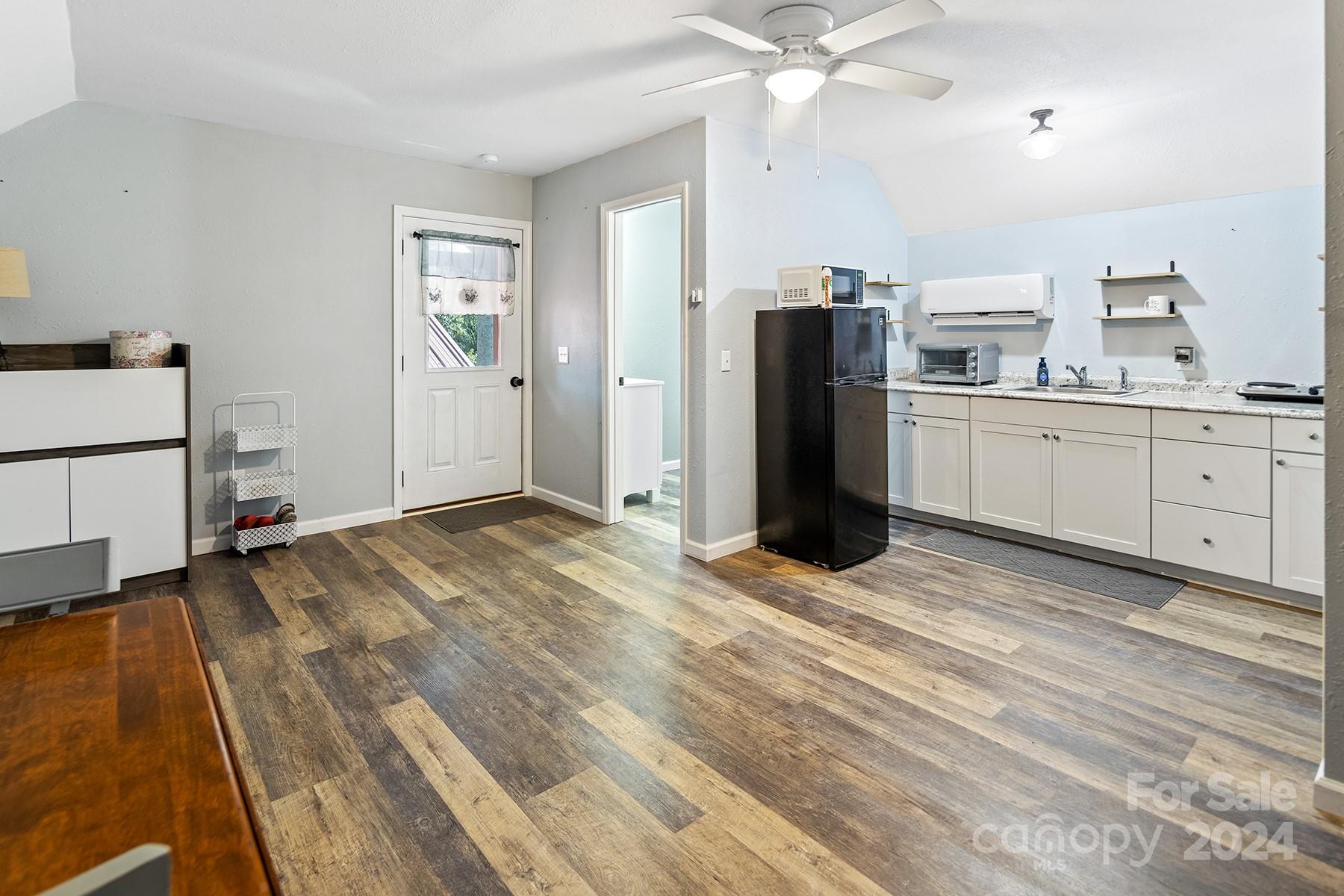 303 Lakeview Road Mocksville, NC 27028 - Photo 34 of 47 a view of a kitchen with a sink refrigerator and wooden floor
