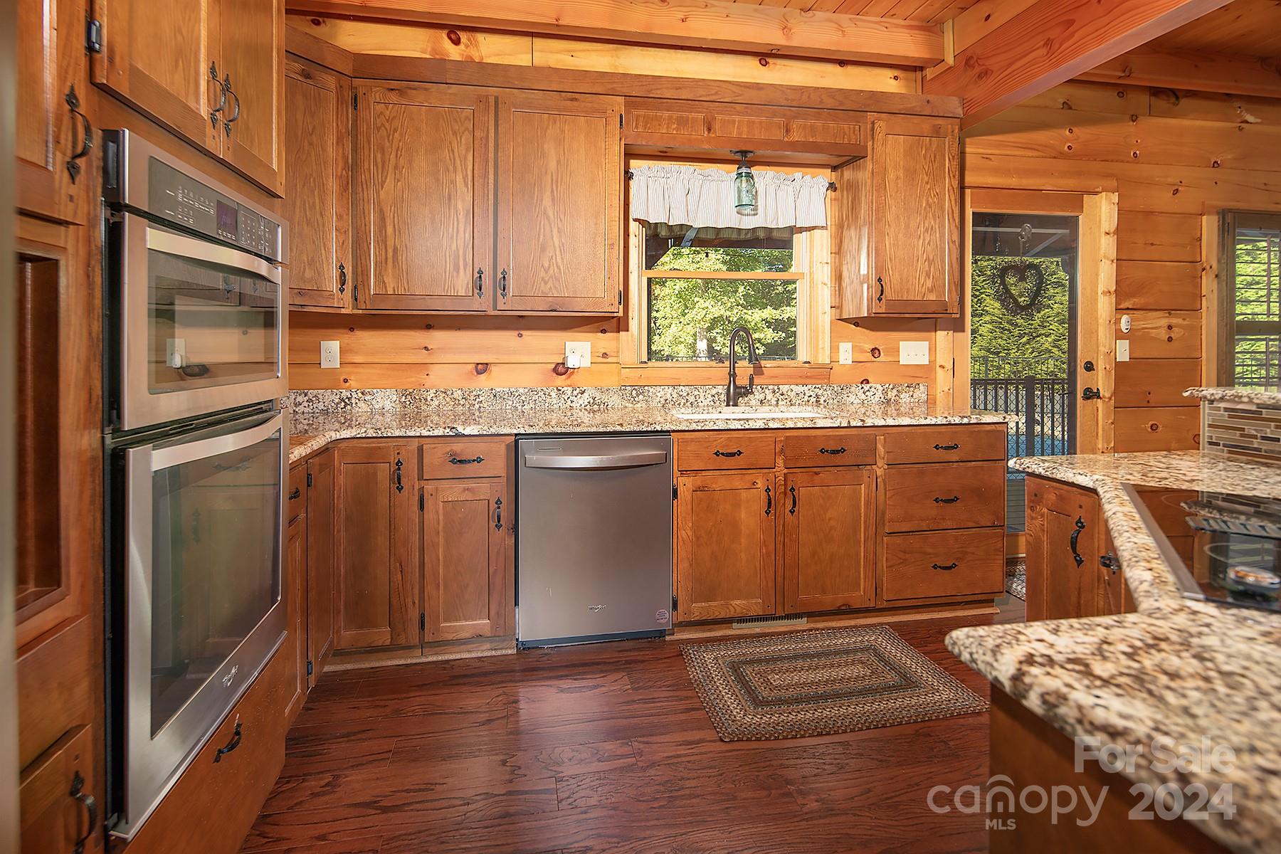303 Lakeview Road Mocksville, NC 27028 - Photo 8 of 47 a kitchen with stainless steel appliances granite countertop a sink and wooden cabinets