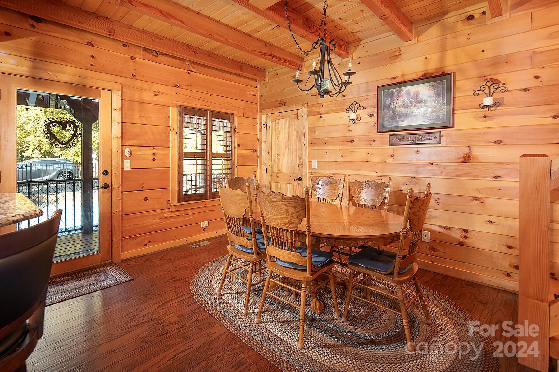 303 Lakeview Road Mocksville, NC 27028 - Photo 9 of 47 a view of a dining room with furniture a chandelier and wooden floor