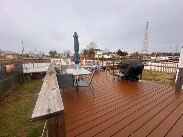 an outdoor sitting area with furniture and wooden floor