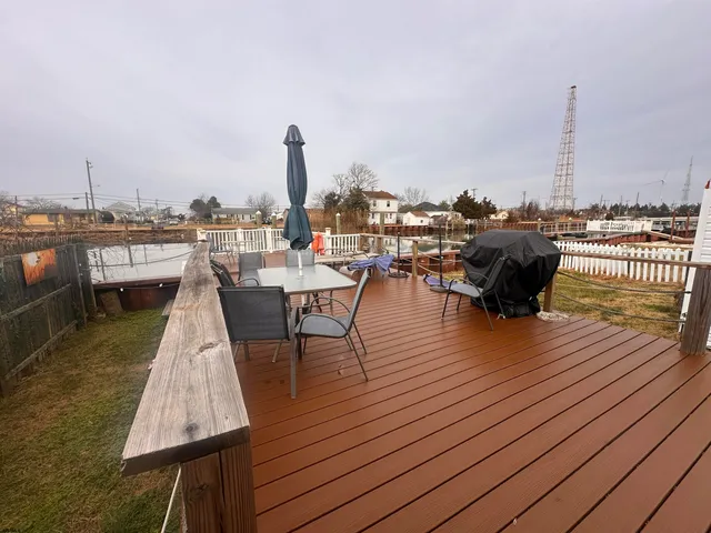 an outdoor sitting area with furniture and wooden floor