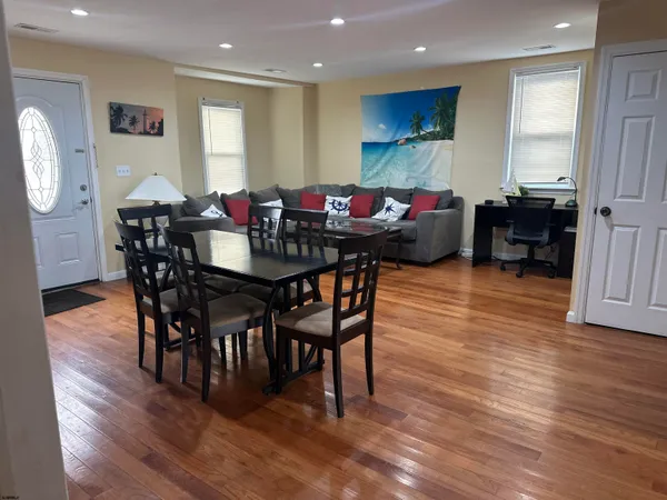 a view of a dining room with furniture and wooden floor