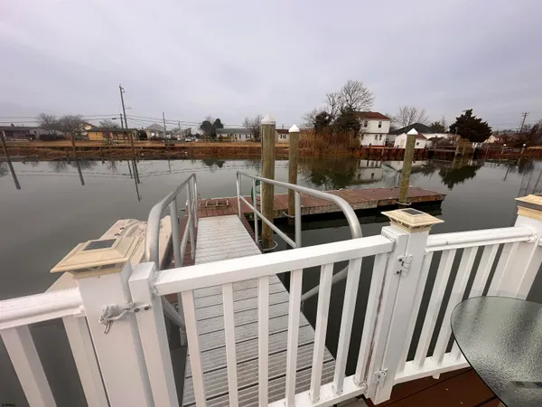 a view of a lake with boats and trees in the background