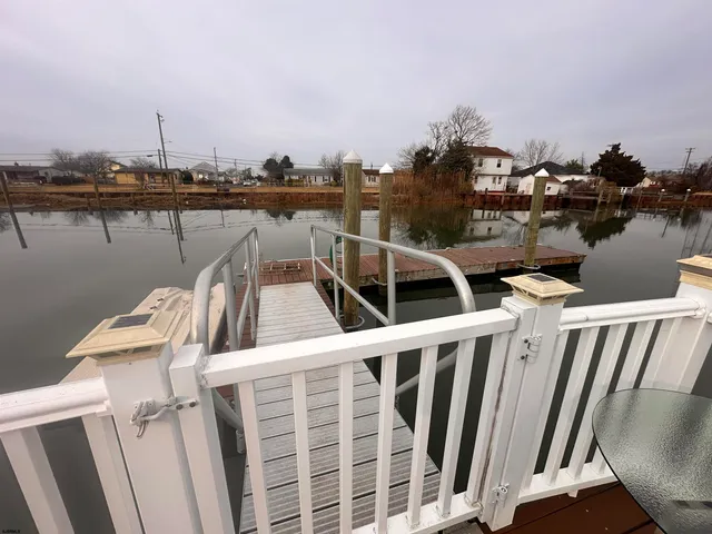 a view of a lake with boats and trees in the background