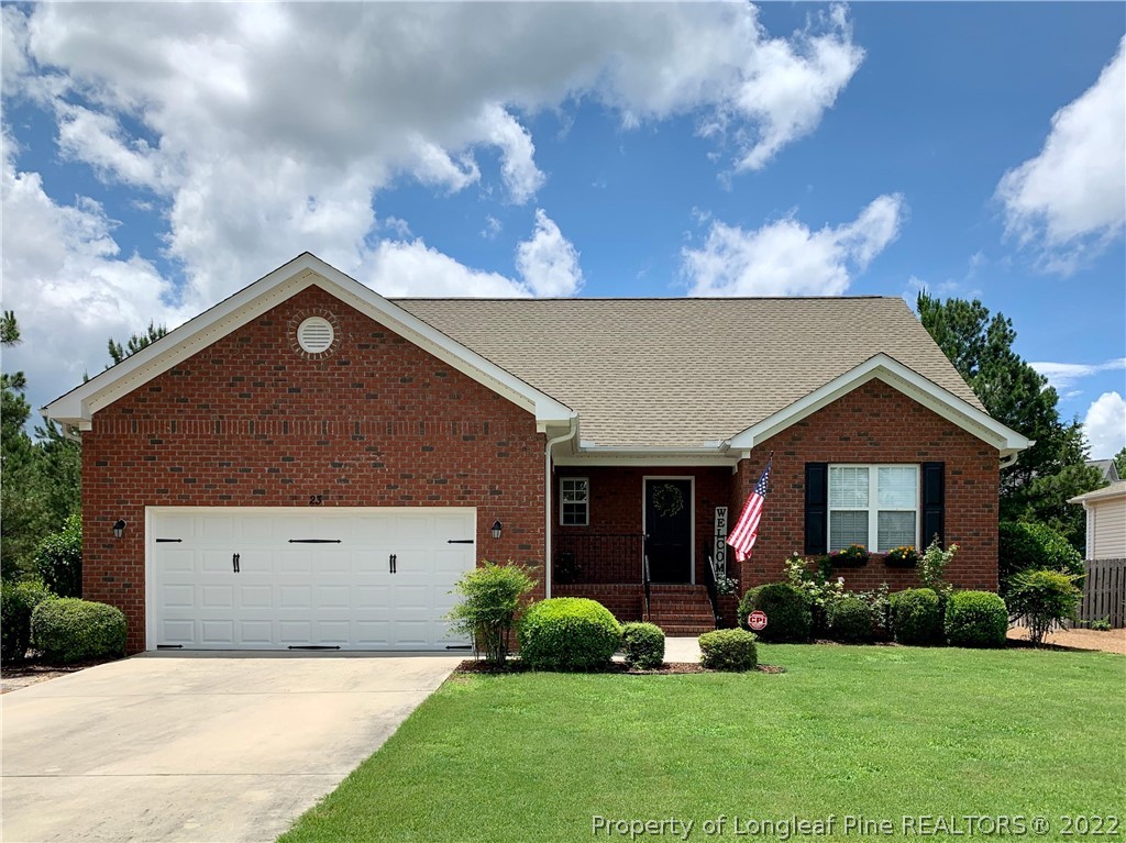 23 Beryl Circle Pinehurst, NC 28374 - Photo 1 of 29 a front view of a house with a yard and garage