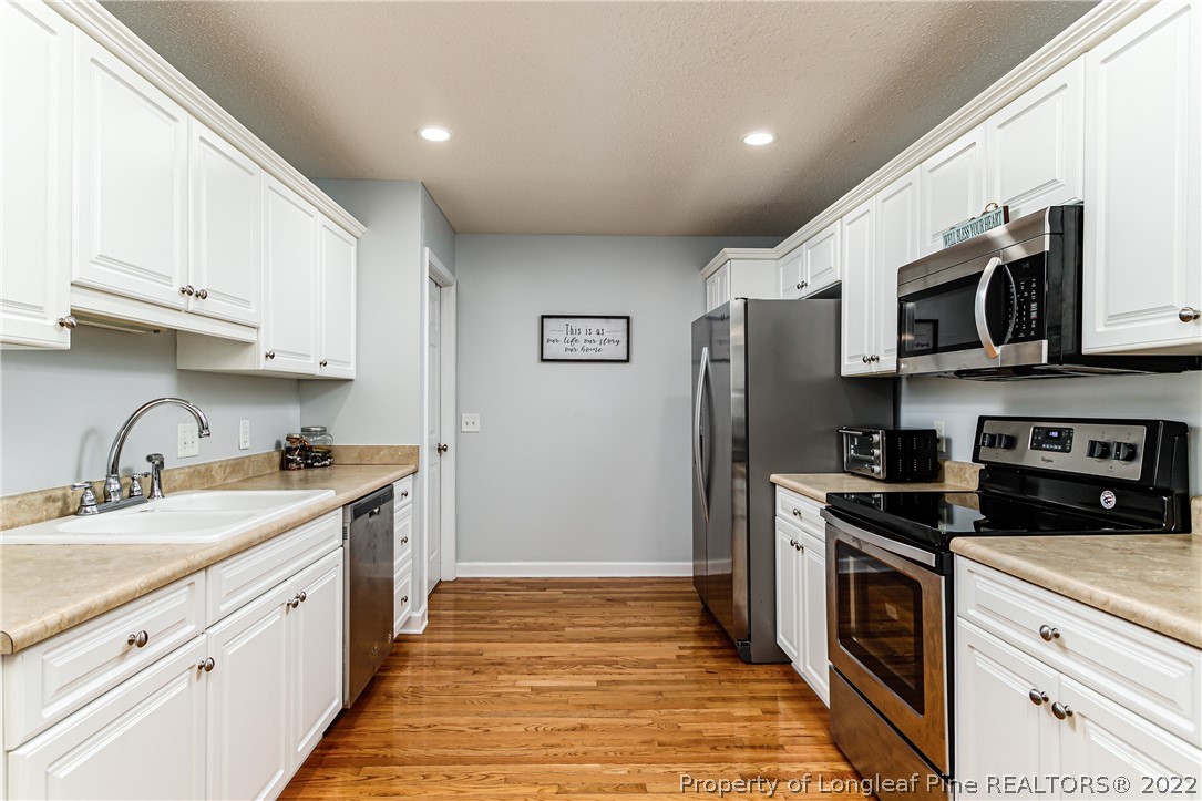 23 Beryl Circle Pinehurst, NC 28374 - Photo 11 of 29 a kitchen with stainless steel appliances granite countertop a refrigerator a stove top oven a sink and dishwasher