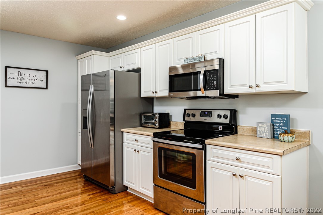 23 Beryl Circle Pinehurst, NC 28374 - Photo 12 of 29 a kitchen with stainless steel appliances granite countertop a stove a refrigerator and a microwave
