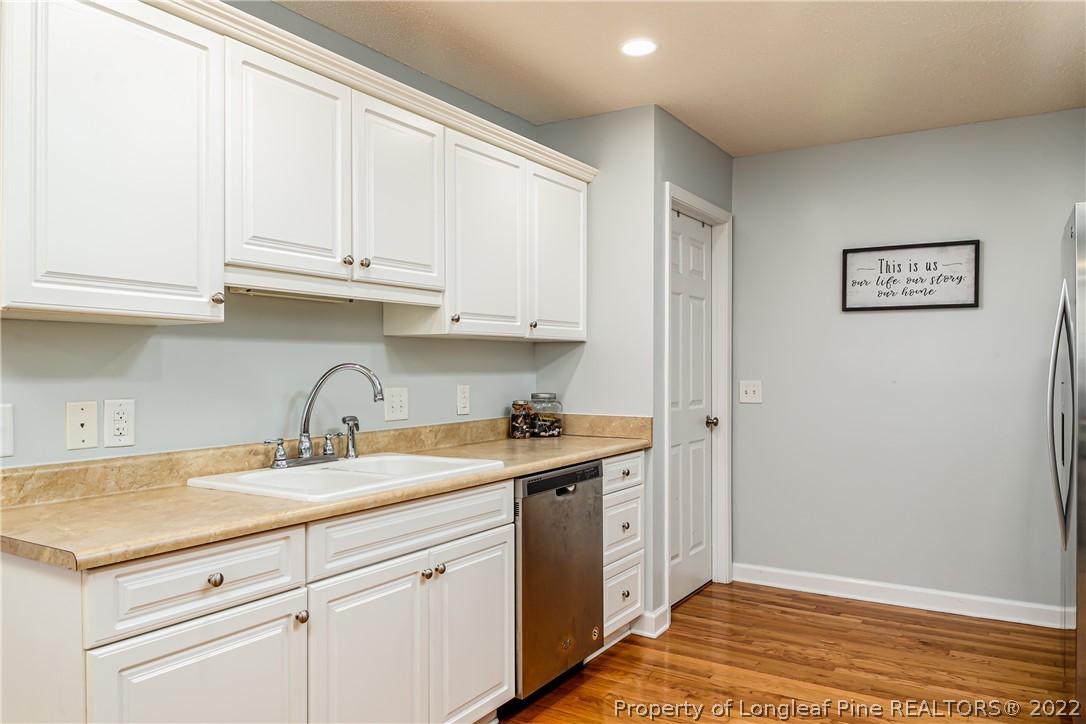 23 Beryl Circle Pinehurst, NC 28374 - Photo 13 of 29 a kitchen with stainless steel appliances granite countertop a sink and dishwasher with white cabinets