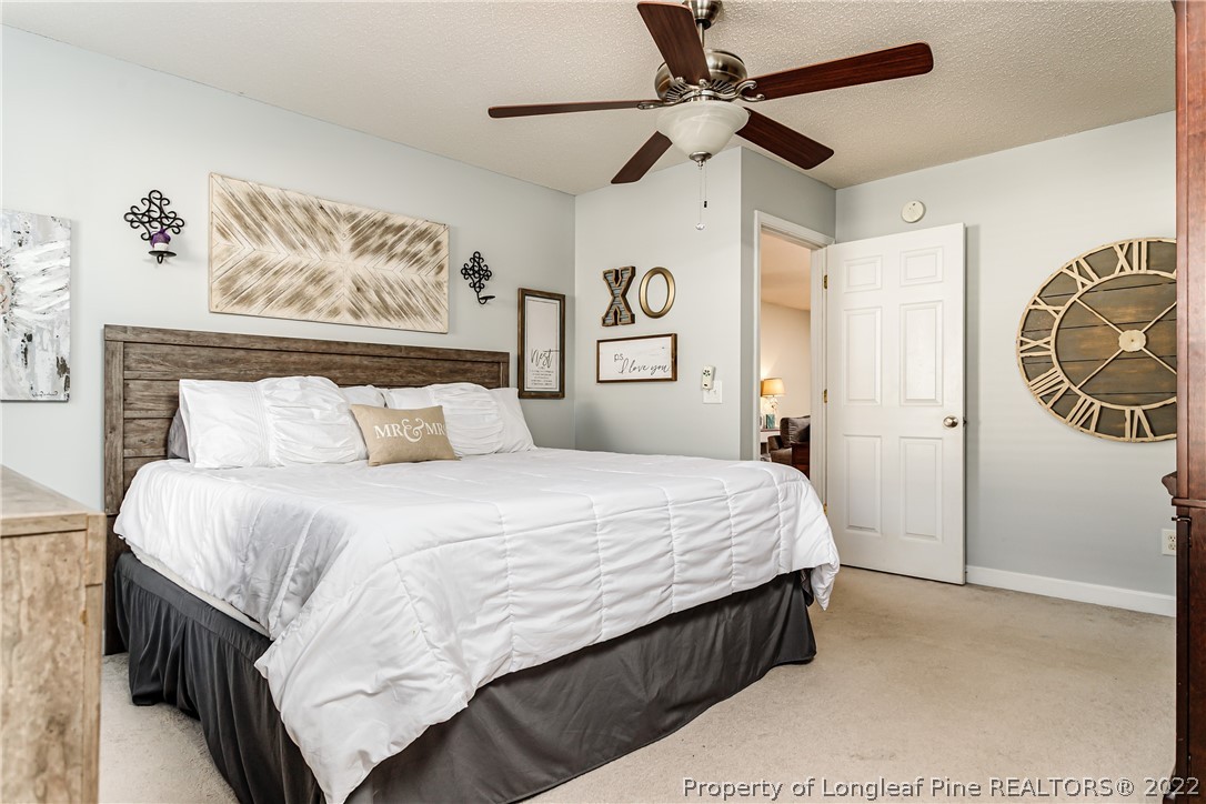 23 Beryl Circle Pinehurst, NC 28374 - Photo 14 of 29 a bedroom with a large bed and a chandelier