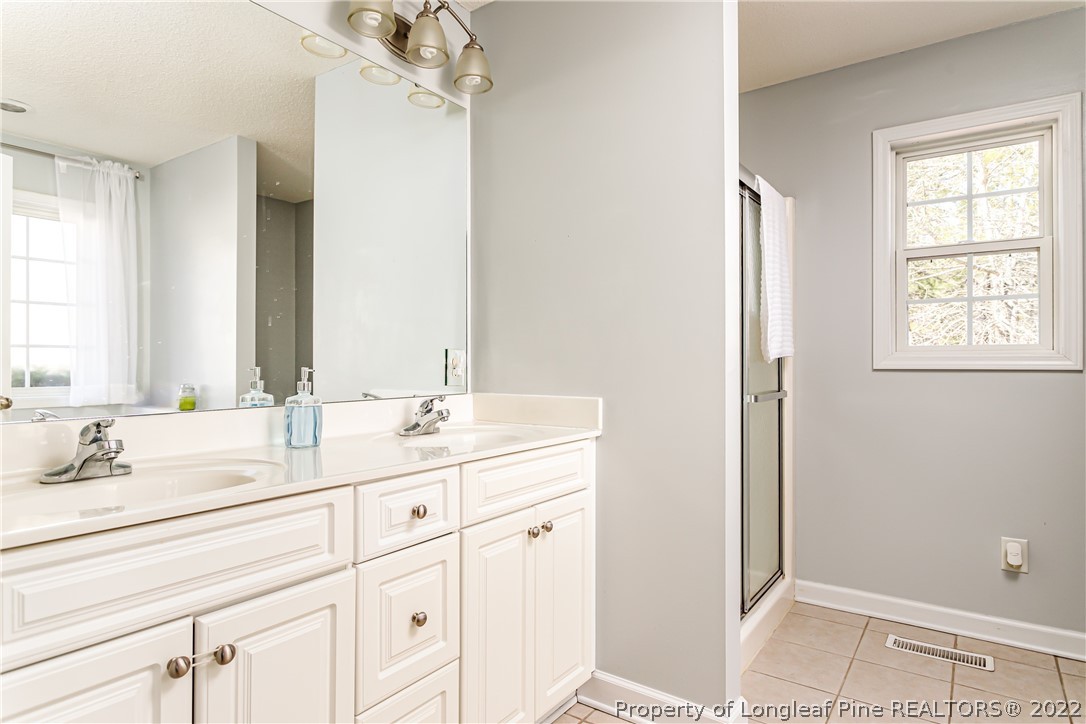 23 Beryl Circle Pinehurst, NC 28374 - Photo 16 of 29 a bathroom with a double vanity sink and a mirror