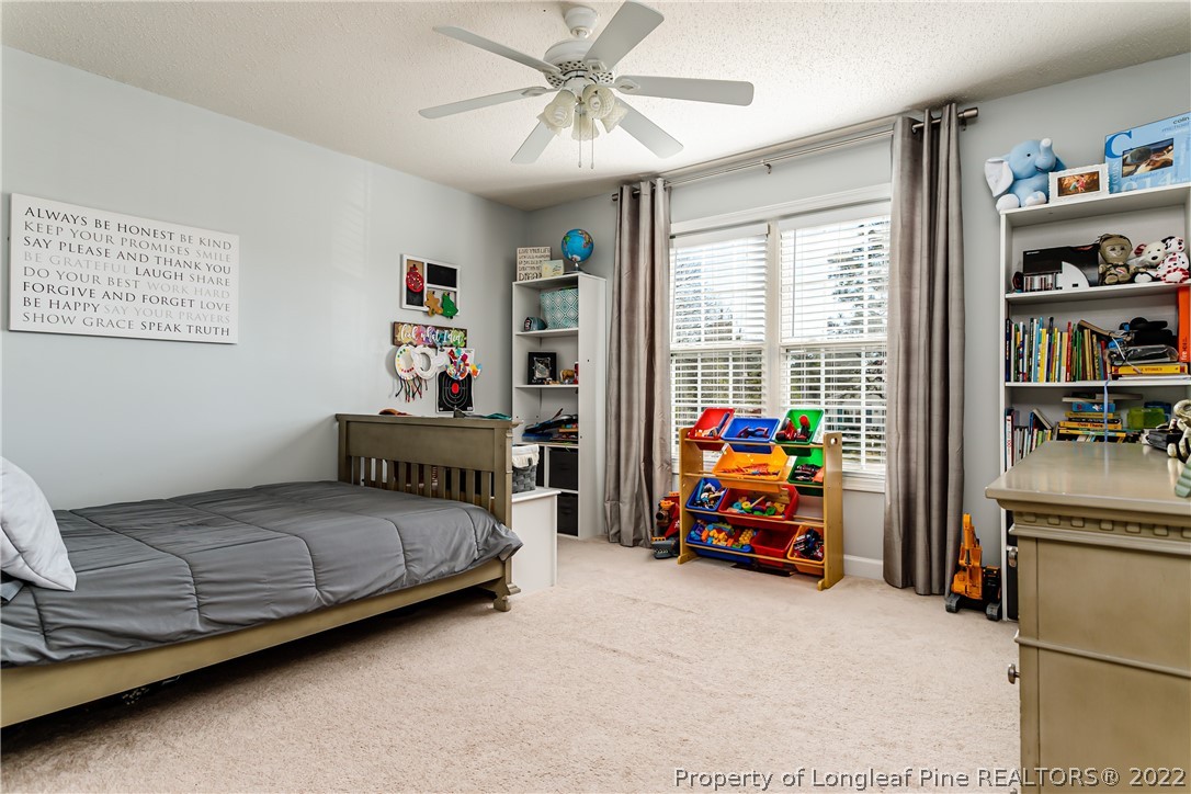 23 Beryl Circle Pinehurst, NC 28374 - Photo 18 of 29 a bedroom with bed and glass windows