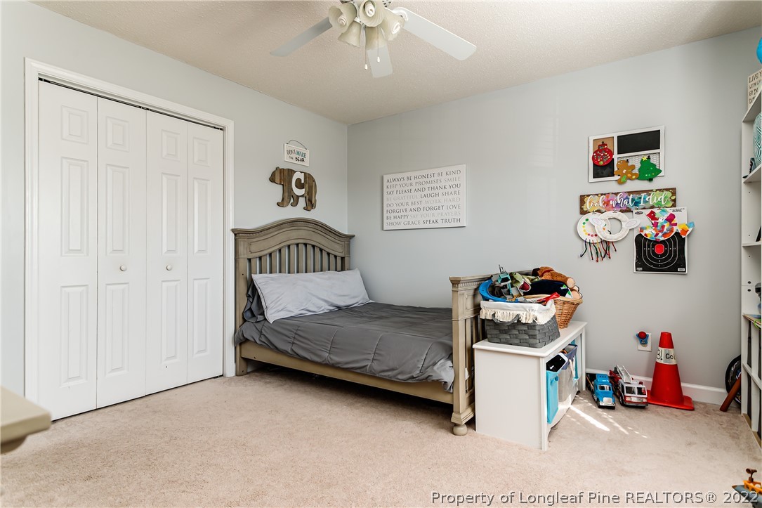 23 Beryl Circle Pinehurst, NC 28374 - Photo 19 of 29 a bedroom with a bed and cabinets