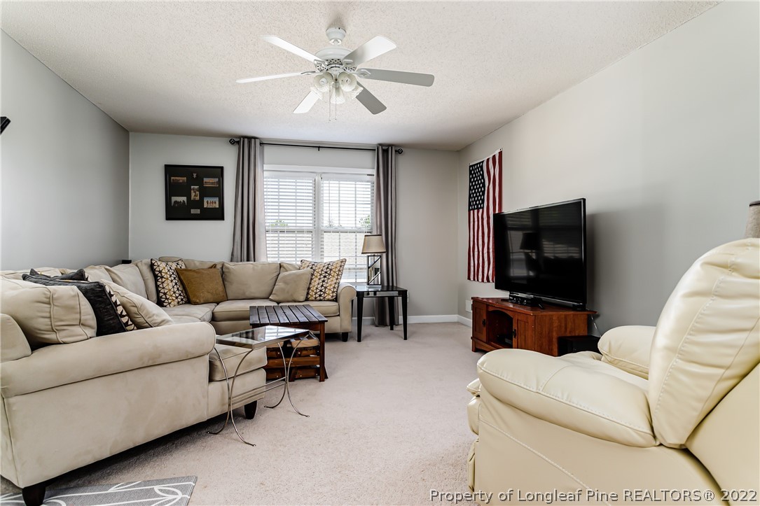 23 Beryl Circle Pinehurst, NC 28374 - Photo 22 of 29 a living room with furniture and a flat screen tv