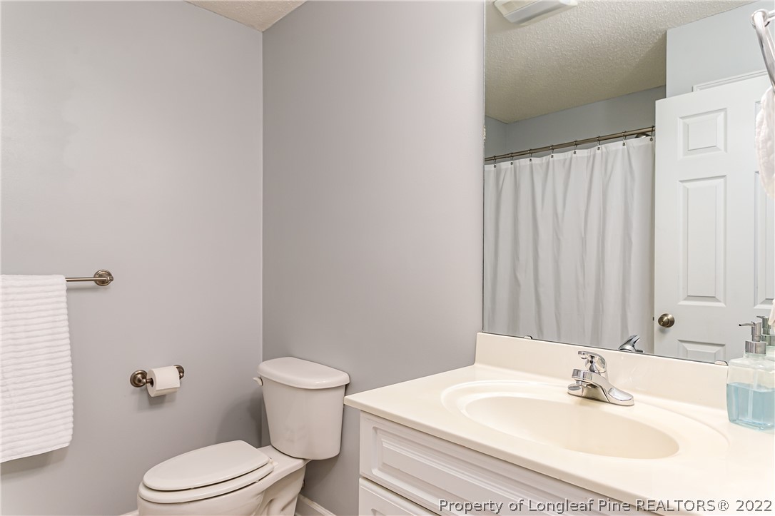 23 Beryl Circle Pinehurst, NC 28374 - Photo 25 of 29 a bathroom with a sink toilet and a mirror