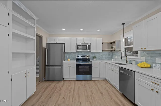 a kitchen with a sink stove and microwave