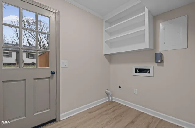 a view of an entryway with wooden floor and a livingroom