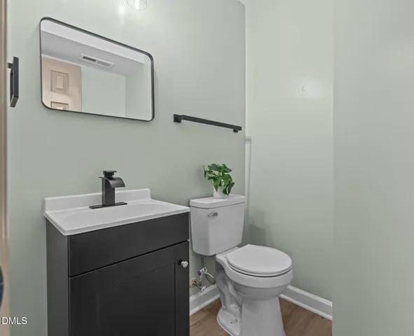 a front view of a house with a yard covered with snow