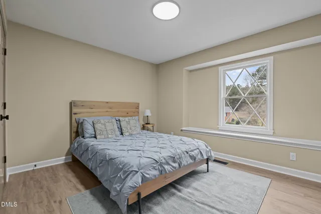 a bedroom with a large bed and a window
