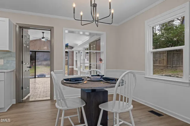 a dining room with furniture and window