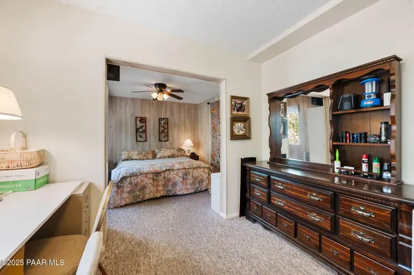 a bedroom with a bed and a book shelf