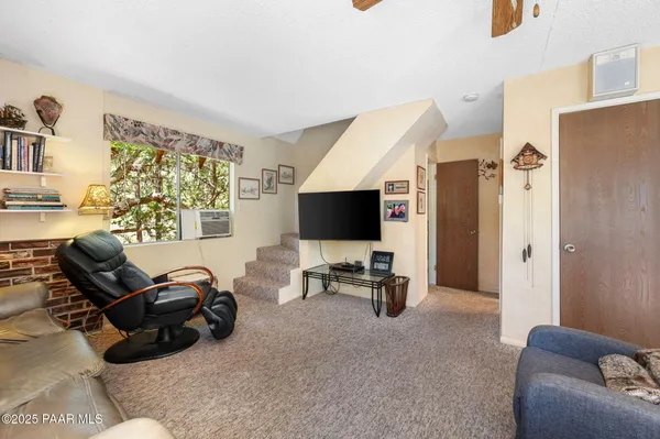 a living room with furniture window and a flat screen tv