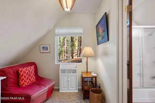 a living room with furniture and a lamp