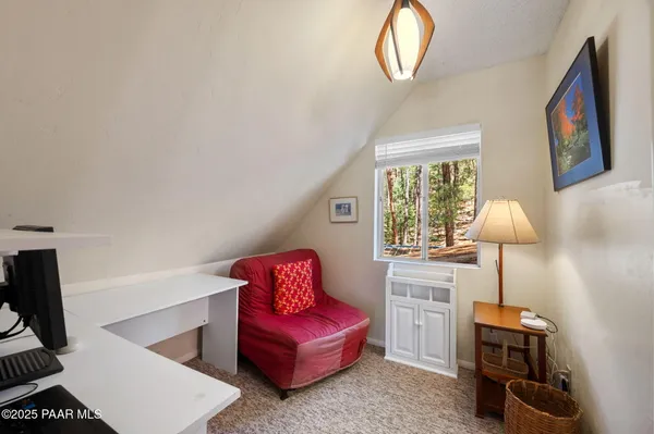 a living room with furniture a window and a lamp