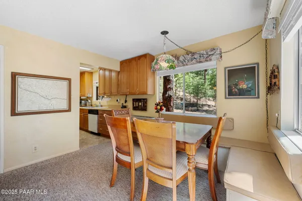 a dining room with furniture a window and appliances