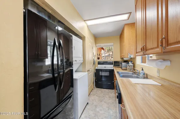 a kitchen with stainless steel appliances granite countertop a refrigerator and a sink