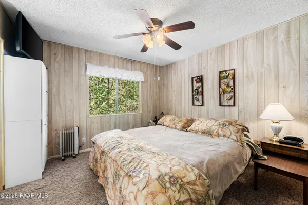 a bedroom with a large bed and a window