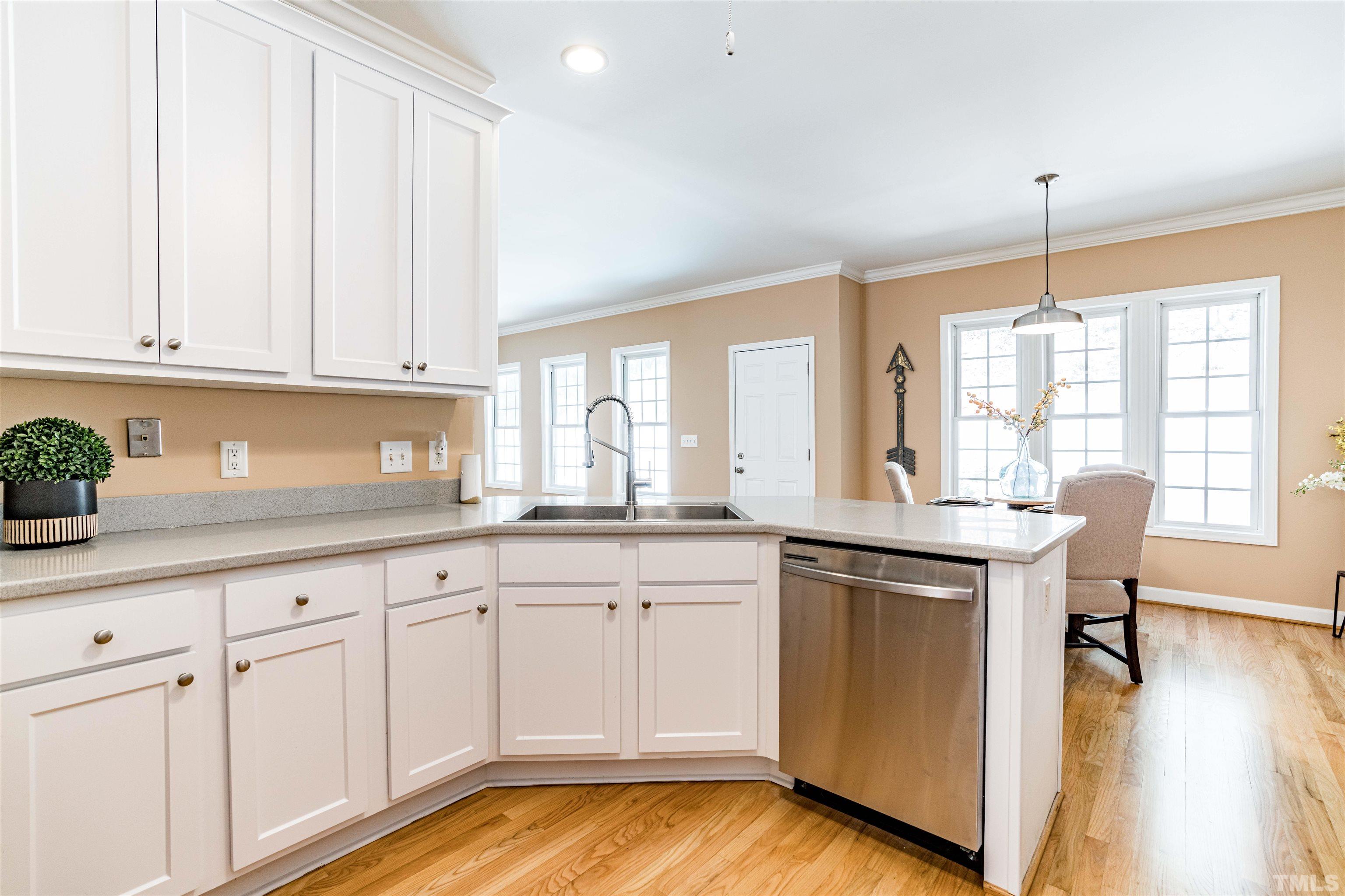 114 Marin Drive Chapel Hill, NC 27516 - Photo 13 of 27 a kitchen with white cabinets and sink