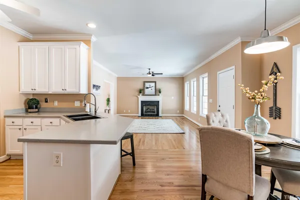 a kitchen with a table chairs and a refrigerator