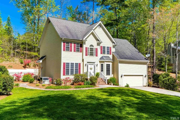 a front view of house with yard and green space