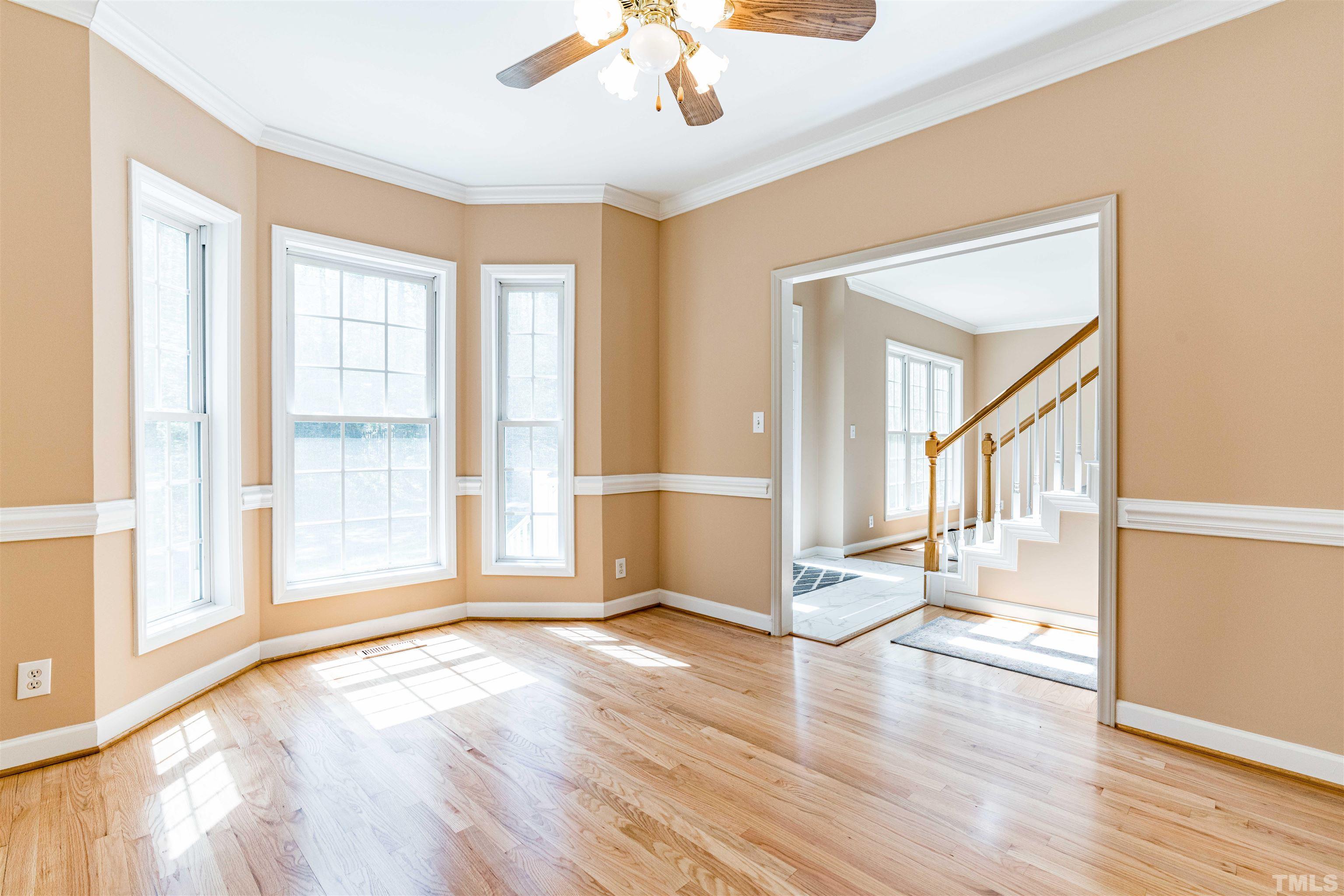 114 Marin Drive Chapel Hill, NC 27516 - Photo 21 of 27 a view of a livingroom with wooden floor and a ceiling fan
