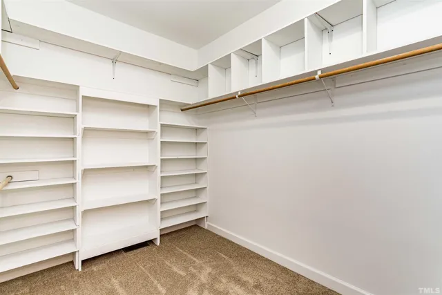 a view of walk in closet with empty racks