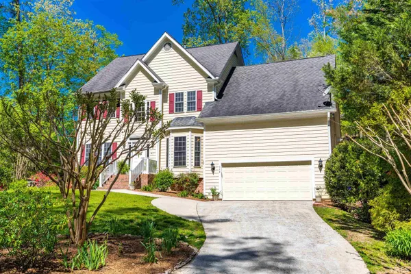 a front view of a house with a yard and outdoor seating