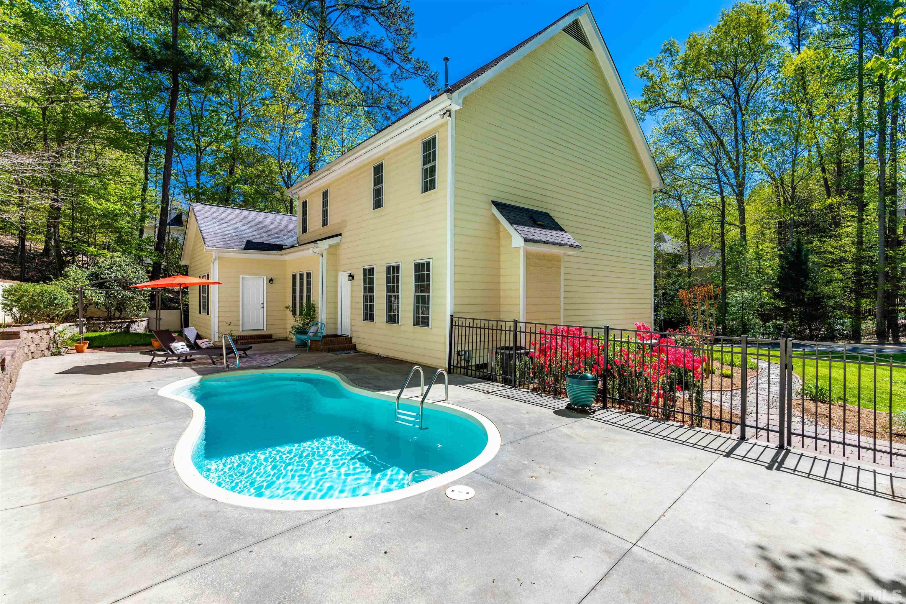114 Marin Drive Chapel Hill, NC 27516 - Photo 6 of 27 a view of a house with backyard sitting area and swimming pool