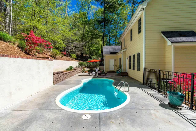 a swimming pool with outdoor seating and yard