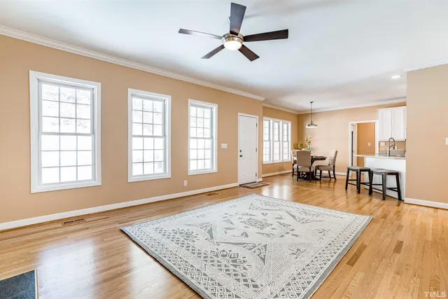 a living room with dining room and wooden floor