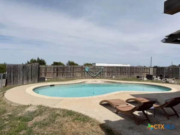 a view of swimming pool with outdoor seating