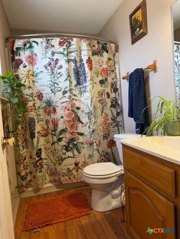 a bathroom with a toilet and a shower curtain