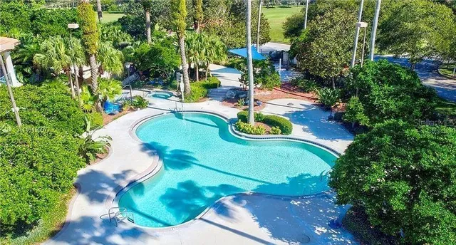 a view of a swimming pool with a yard