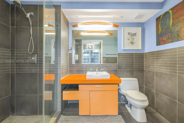 a bathroom with a toilet and shower