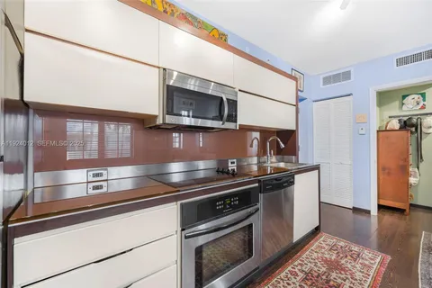 a kitchen with stainless steel appliances granite countertop a stove and a microwave