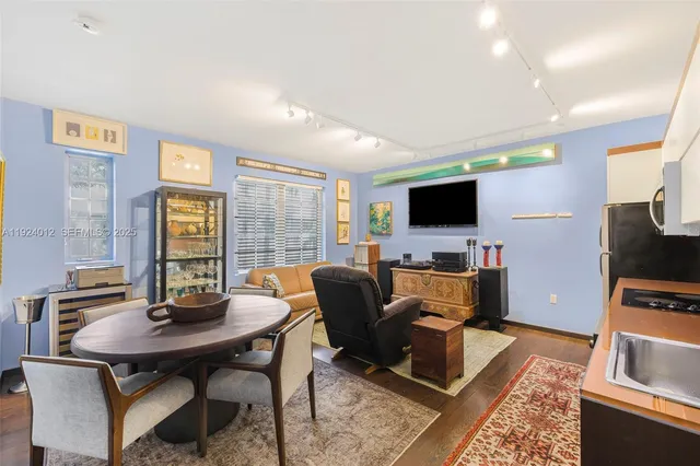 a view of a livingroom with furniture and a flat screen tv