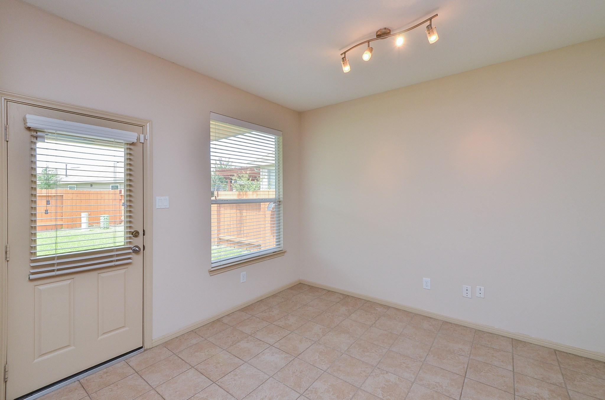25135 Ginger Ranch Drive Katy, TX 77494 - Photo 10 of 32 A bright breakfast area with tile flooring and backyard access provides a comfortable space for everyday meals or casual gatherings.