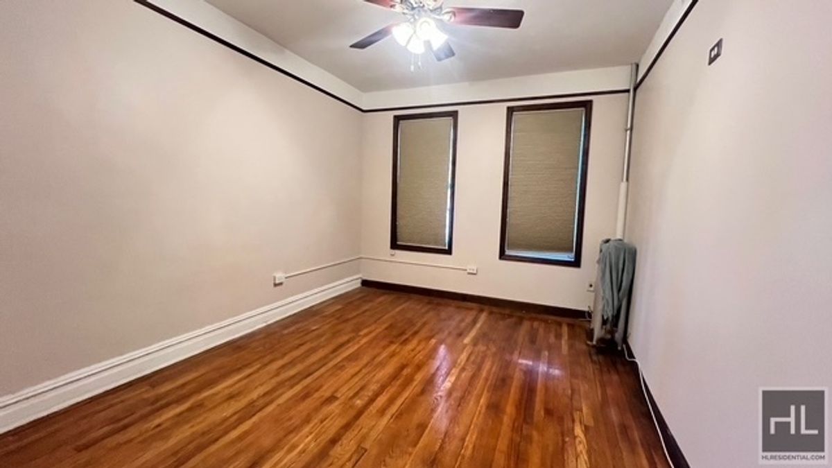 797 Lenox Road, Unit 1 Brooklyn, NY 11203 - Photo 8 of 21 a view of an empty room with wooden floor and a window
