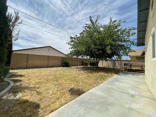 1133 West Benson Avenue Ridgecrest, CA 93555 - Photo 28 of 34 a house with trees in front of it