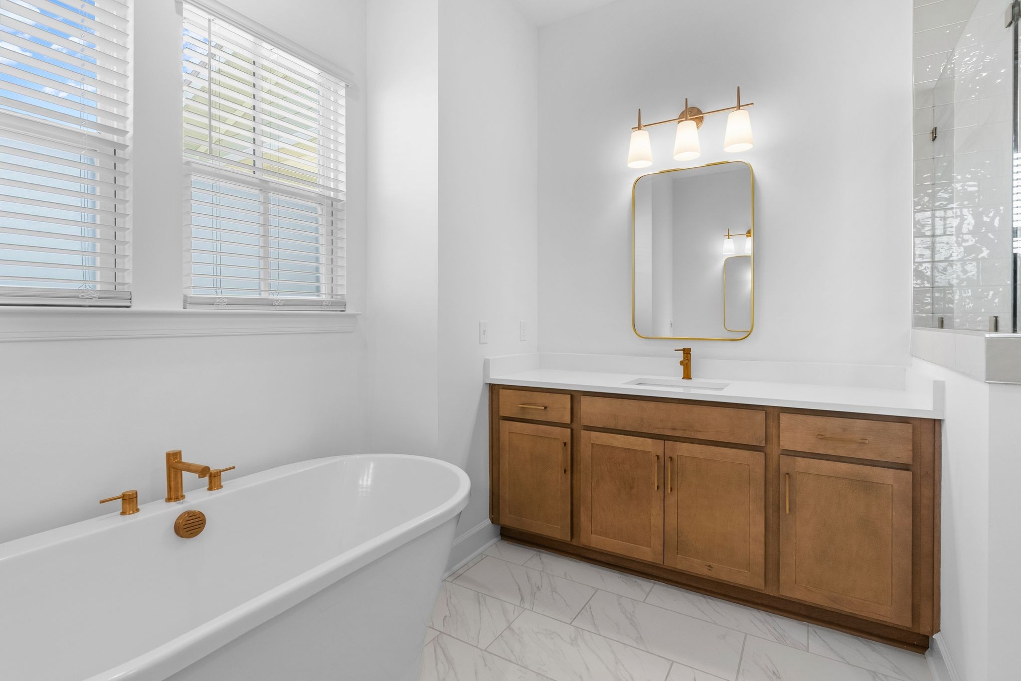 7440 Atwater Circle Fairview, TN 37062 - Photo 20 of 43 a bathroom with a tub sink and mirror