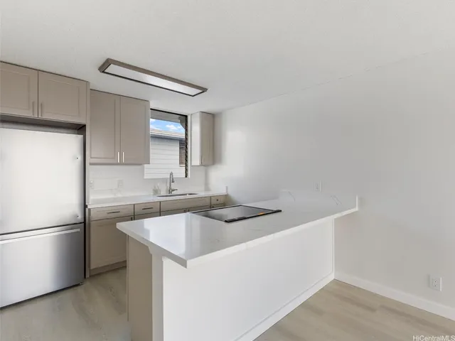 a kitchen that has a sink and stainless steel appliances
